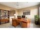 Bright office boasts a large wooden desk, plush rug, and a wall of custom shelving at 11082 E Mark Ln, Scottsdale, AZ 85262