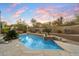 Inviting pool featuring a stone deck, desert landscaping, and sunset views creates a serene outdoor oasis at 11082 E Mark Ln, Scottsdale, AZ 85262