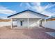 Exterior view of home showcasing the covered patio, rock landscaping, and well maintained yard at 1133 E 4Th St, Casa Grande, AZ 85122