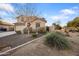 Beautiful front exterior highlighting a two-story home with low maintenance desert landscaping at 11451 E Starkey Ave, Mesa, AZ 85212