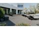 Inviting backyard with lounge chairs, striped umbrellas, and direct access to the pool at 11745 N 99Th St, Scottsdale, AZ 85260