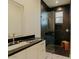 Modern bathroom featuring a marble countertop and sleek black tiled shower at 11745 N 99Th St, Scottsdale, AZ 85260