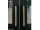 A close up of kitchen cabinet handles with stylish detailing and dark cabinetry at 11745 N 99Th St, Scottsdale, AZ 85260