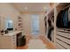 Bright walk-in closet with vanity, shelving and access to a modern bathroom, offering convenience and style at 11745 N 99Th St, Scottsdale, AZ 85260