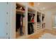 Spacious walk-in closet featuring custom shelving and ample storage space for clothing and accessories at 11745 N 99Th St, Scottsdale, AZ 85260