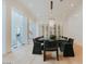 Spacious dining room boasts a modern wine cellar and statement chandelier at 11745 N 99Th St, Scottsdale, AZ 85260