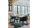 Dining room with an oval table, black chairs, and a floor-to-ceiling window showcasing outdoor views at 11745 N 99Th St, Scottsdale, AZ 85260