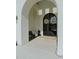 Beautiful entryway that is framed by arches and decorated with wreaths at 11745 N 99Th St, Scottsdale, AZ 85260