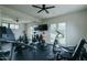 Modern exercise room with floor-to-ceiling mirror and wall-mounted tv for entertainment at 11745 N 99Th St, Scottsdale, AZ 85260