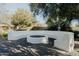 Stylish outdoor firepit with built-in seating, creating a warm and inviting space for entertaining and relaxation at 11745 N 99Th St, Scottsdale, AZ 85260