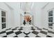 Grand foyer with black and white flooring and staircase at 11745 N 99Th St, Scottsdale, AZ 85260