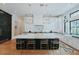 Open kitchen showcasing a marble island with seating, modern lights, and custom black and white cabinets at 11745 N 99Th St, Scottsdale, AZ 85260