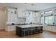 Bright kitchen with stainless steel appliances, marble island, modern lighting, and counter seating at 11745 N 99Th St, Scottsdale, AZ 85260