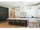 Spacious kitchen features a marble island with seating, modern lighting, and custom black and white cabinetry at 11745 N 99Th St, Scottsdale, AZ 85260