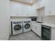 Clean laundry room with modern appliances and storage at 11745 N 99Th St, Scottsdale, AZ 85260
