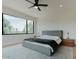 Bright main bedroom with large window, neutral tones, ceiling fan and sleek furniture with soft carpet at 11745 N 99Th St, Scottsdale, AZ 85260