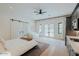 Bright main bedroom with barn door, seating area, and a modern kitchenette at 11745 N 99Th St, Scottsdale, AZ 85260