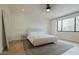 Stylish main bedroom with plush bed, large window, soft rug, providing a peaceful retreat at 11745 N 99Th St, Scottsdale, AZ 85260