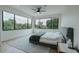 Serene main bedroom featuring large windows, a ceiling fan, and plush carpeting for ultimate comfort at 11745 N 99Th St, Scottsdale, AZ 85260