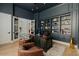 A sophisticated home office with custom built-ins and rich, dark accents at 11745 N 99Th St, Scottsdale, AZ 85260