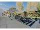 Outdoor kitchen offers bar seating, a dining table, and serene backyard views, for entertaining at 11745 N 99Th St, Scottsdale, AZ 85260