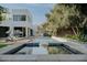 Stunning pool and patio area featuring a waterfall, elegant seating, and lush landscaping, perfect for outdoor gatherings at 11745 N 99Th St, Scottsdale, AZ 85260