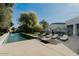 Inviting pool area featuring lounge chairs, umbrellas, and a sleek modern design perfect for relaxing and entertaining outdoors at 11745 N 99Th St, Scottsdale, AZ 85260