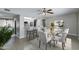 Bright dining room featuring a ceiling fan and a glass-topped table with seating for eight at 1206 E Greenway Dr, Tempe, AZ 85282