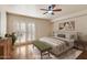 Comfortable bedroom with a ceiling fan, light-colored walls, shutters and wooden floors at 1221 E Palacio Dr, Phoenix, AZ 85014