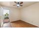 Bedroom features wood floors, a ceiling fan, and a view of a private outdoor patio, creating a serene retreat at 1221 E Palacio Dr, Phoenix, AZ 85014