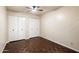 Bedroom featuring a parquet floor, ceiling fan, and double closets offering generous storage at 1221 E Palacio Dr, Phoenix, AZ 85014