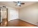 Hardwood floors and a ceiling fan complement this bedroom, which also offers double closet space at 1221 E Palacio Dr, Phoenix, AZ 85014