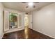 Cozy bedroom with a ceiling fan, parquet floors, a view through the window, and access to an ensuite bathroom at 1221 E Palacio Dr, Phoenix, AZ 85014
