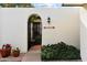 Inviting gated entry featuring an arched gate and colorful potted plants at 1221 E Palacio Dr, Phoenix, AZ 85014