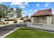 Charming community entrance featuring lush landscaping and classic Santa Fe architecture at 1221 E Palacio Dr, Phoenix, AZ 85014