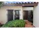 Charming home entrance with a secure wrought-iron gate, tiled walkway, and lush, mature landscaping at 1221 E Palacio Dr, Phoenix, AZ 85014