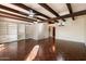 Bright living room with wood floors, beamed ceilings and built-in shelving at 1221 E Palacio Dr, Phoenix, AZ 85014