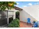 Private brick patio with stylish blue seating amidst lush landscaping at 1221 E Palacio Dr, Phoenix, AZ 85014