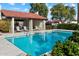Sparkling community pool with lounge chairs, poolside lounge area, and manicured landscaping at 1221 E Palacio Dr, Phoenix, AZ 85014