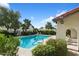 Community swimming pool with clear blue water, surrounded by mature trees and landscaping, lounge chairs at 1221 E Palacio Dr, Phoenix, AZ 85014