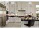 Bright kitchen with white cabinets, stainless steel appliances, and sleek black countertops at 12245 E Clinton St, Scottsdale, AZ 85259