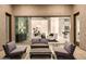 An outdoor patio with seating and a view into the living room at 12245 E Clinton St, Scottsdale, AZ 85259