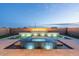 Stunning pool features integrated lighting, water features, and lush landscaping at 12245 E Clinton St, Scottsdale, AZ 85259