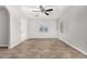 Spacious living room featuring wood-look floors, neutral paint, and a ceiling fan at 1401 N Houck St, Casa Grande, AZ 85122