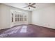 A bedroom with large bay windows, neutral paint, and a ceiling fan at 14817 W Domingo Ln, Sun City West, AZ 85375