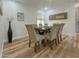 Elegant dining room featuring a stylish table with six chairs, wood floors, and decorative accents at 15021 N 7Th Dr, Phoenix, AZ 85023