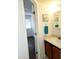 This bathroom has a sink with wood cabinets and a view into another room at 16402 N 31St St # 134, Phoenix, AZ 85032