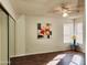 Bedroom with wood laminate flooring, ceiling fan, and closet at 16402 N 31St St # 134, Phoenix, AZ 85032