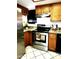 Updated kitchen with stainless steel appliances, wood cabinets, and tile floors at 16402 N 31St St # 134, Phoenix, AZ 85032
