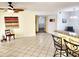 Living room featuring ceramic tile flooring, breakfast bar, and neutral paint at 16402 N 31St St # 134, Phoenix, AZ 85032